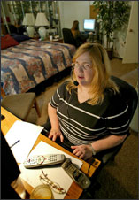 woman on headset at computer at home